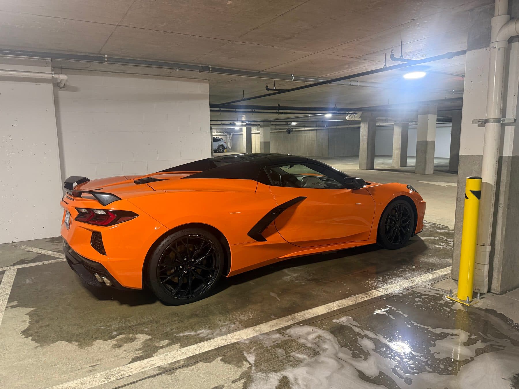 Orange Corvette C8 detailed in a parking garage